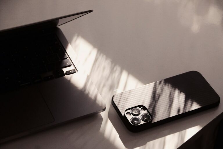 Phone beside laptop on a desk, illustrating subscription planning